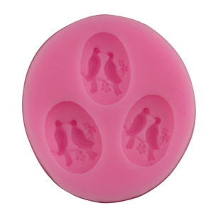 Pink circular silicone fondant mold featuring three detailed 3D bird pairs on branches