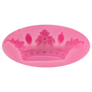 Macro detail of a pink silicone mold showing a 3D crown design for cake decorating