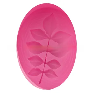 Macro shot of leaf branch pattern inside an oval pink silicone cake fondant mold