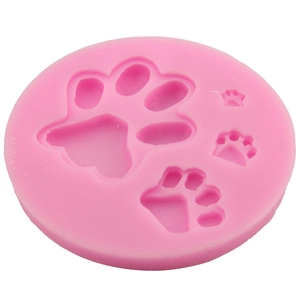 Pink silicone mold featuring four paw prints for baking and chocolate making crafts