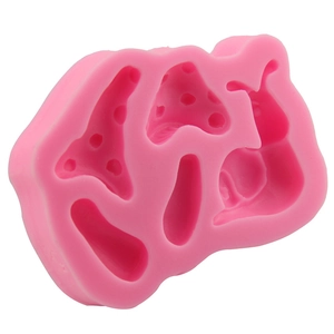 Pink silicone mold featuring fairy tale snail and mushroom shapes for fondant cake decoration