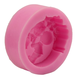 Pink silicone fondant mold featuring detailed little girl and boy figures for cake decor