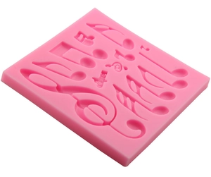 Pink silicone music note fondant mold featuring treble clef and musical symbols for baking