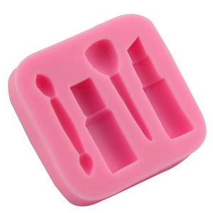 Pink silicone fondant mold featuring makeup tools like lipstick, brushes, and nail polish