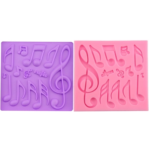 Detail of pink and purple silicone musical note molds for fondant and chocolate cake decoration