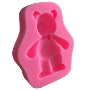 Macro view of bright pink 3D teddy bear silicone mold with detailed bow tie for DIY crafts