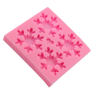 Pink silicone mold featuring delicate snowflake and heart shapes for baking decoration