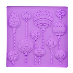 Purple silicone fondant mold with diverse 3D Christmas ball and star shapes for baking
