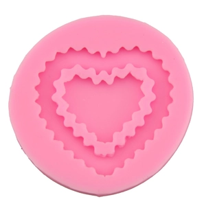 Pink heart-shaped silicone mold with nested wave textures for fondant and cakes