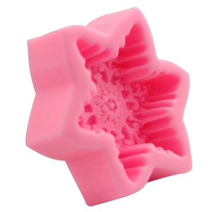 Pink silicone snowflake soap mold with star exterior and detailed snowflake pattern
