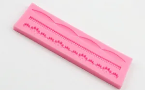 Pink silicone fondant mold with wavy lace and bead patterns for cake decorating