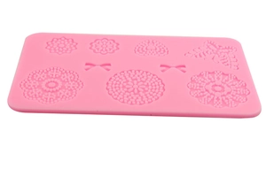 Pink silicone cake mold with butterfly and floral embossed patterns for fondant decorating
