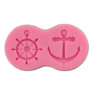Pink silicone mold featuring nautical anchor and ship wheel shapes for cake decorating