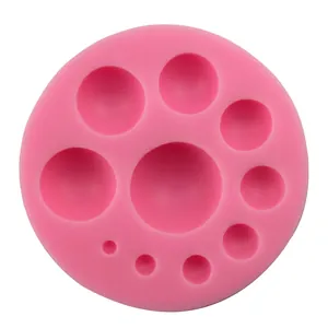 Pink silicone mold with nine hemispherical cavities for DIY fondant and cake decorating