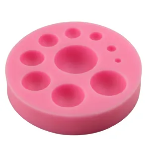 Pink silicone cake mold with seven diverse semi-sphere cavities for DIY baking
