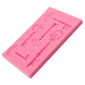 Pink silicone fondant mold featuring five vintage key shapes for DIY cake decorating