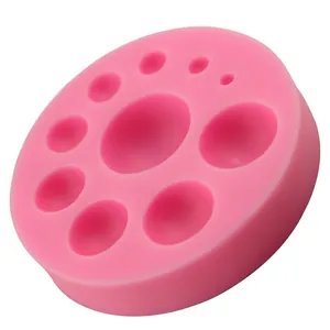 Pink silicone mold with circular and oval cavities for DIY cake decorating and baking