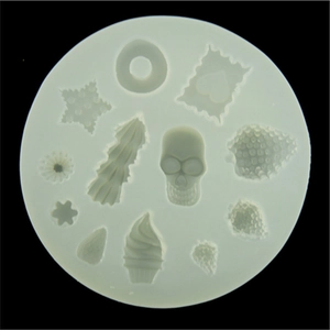 Silicone mold with 12 cavities for clay desserts including skull and heart shapes