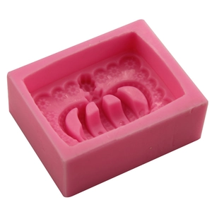Pink rectangular silicone mold with intricate crown and flower relief patterns for DIY baking