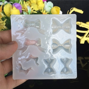 Translucent silicone mold with 8 bow tie shapes for DIY resin jewelry making crafts