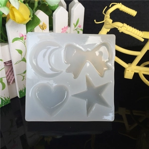 Translucent silicone mold featuring moon, bow, heart, and star shapes for DIY resin crafts