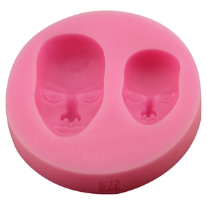 Pink silicone fondant mold featuring male and female faces for DIY chocolate and soap making