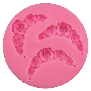 Pink silicone mold featuring three rose floral patterns for fondant cake decoration