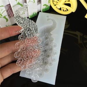 Peacock shape silicone mold for DIY resin craft showing a finished 3D transparent peacock