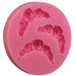 Pink round silicone mold featuring three rose flower patterns for fondant and clay DIY crafts