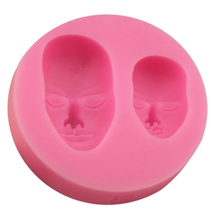 Pink silicone mold featuring two realistic human face cavities for DIY fondant and soap