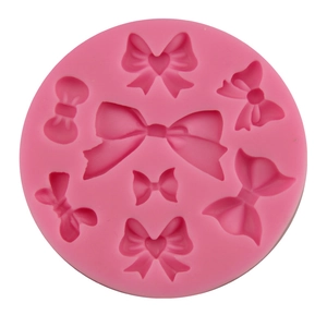 Pink silicone mold with 7 unique bow shapes for fondant, chocolate, and DIY cake baking decor