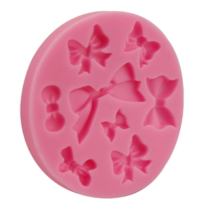 Pink silicone round mold featuring 8 diverse bow-knot designs for cake fondant DIY baking