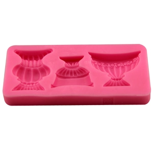 Pink silicone mold with three vintage vase shapes and detailed relief patterns for baking