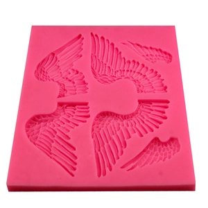 Pink silicone fondant mold featuring large angel wings for DIY cake decorating
