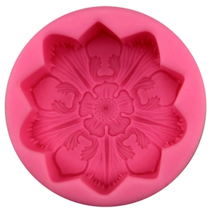 Pink silicone flower cake mold with detailed eight-petal floral texture for fondant
