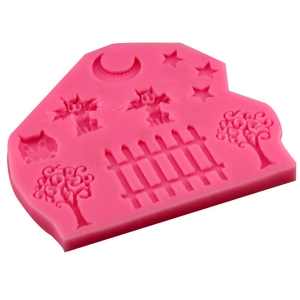 Pink silicone mold featuring moon, stars, gargoyle, and fence for cake decorating