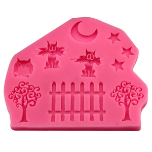 Pink silicone mold featuring moon, stars, owls, and fence shapes for cake decorating