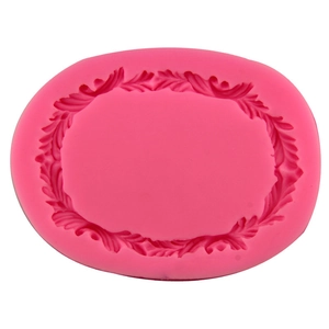Pink silicone fondant mold featuring intricate vine and leaf oval frame for cake decoration
