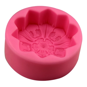 Pink silicone mold featuring an intricate five-petal flower design for cake decoration