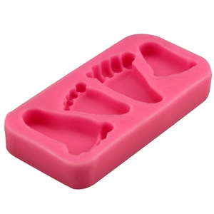 Pink silicone mold with three different sizes of baby foot shapes for fondant or chocolate