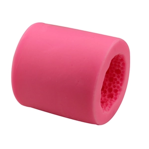 Pink cylindrical silicone mold with dense internal honeycomb texture for soap and cakes