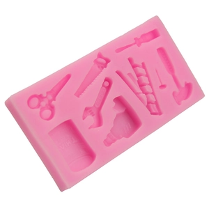 Pink silicone mold featuring various hardware tools like scissors, hammer and wrench
