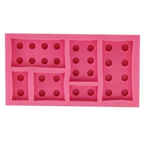 Macro shot of rose pink silicone brick mold showing detailed building block textures
