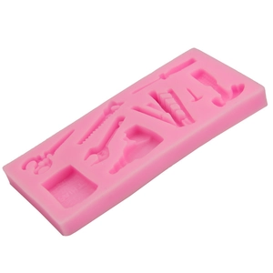 Pink silicone mold featuring various hardware tools like hammer and wrench for fondant DIY