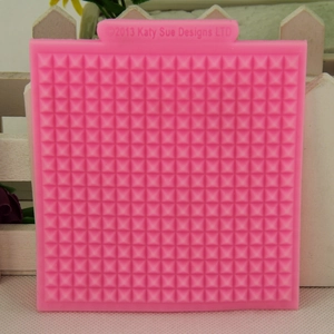 Pink silicone waffle pattern fondant mold with geometric pyramid texture for cake lace