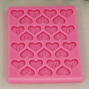 Pink heart-shaped silicone mold featuring 26 uppercase English letters for DIY baking