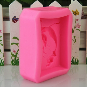 Pink silicone mermaid tail soap mold with detailed embossed patterns for cake decorating