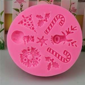 Pink silicone Christmas mold featuring reindeer, snowman, and tree for cake decorating