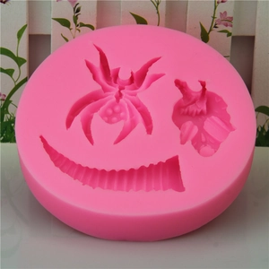 Pink silicone Halloween mold featuring detailed spider and skull for baking and DIY soaps