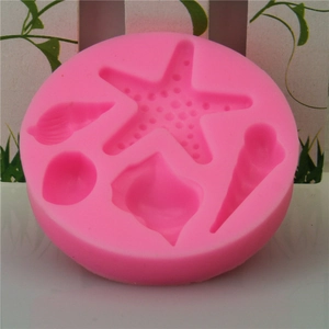 Pink silicone mold featuring starfish and seashells for chocolate or fondant decorating